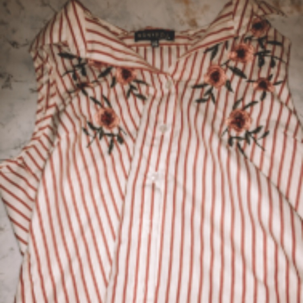 A bright sleeveless button down shirt. ☮️